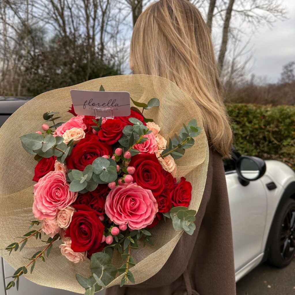 girl holding red flowers